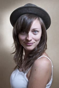 Studio portrait of young woman wearing a hat.