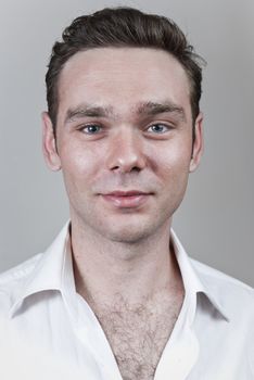Headshot of young white man with neutral gray background.
