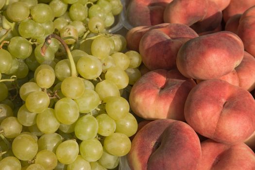 Grapes and peaches for sale at the market.