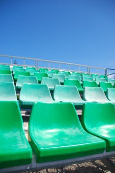 photo of green stadium bleachers on the beach