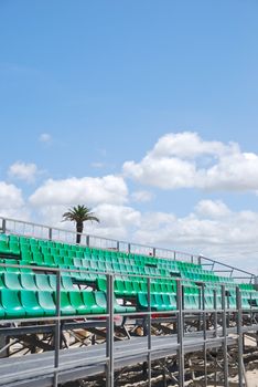 photo of green stadium bleachers on the beach