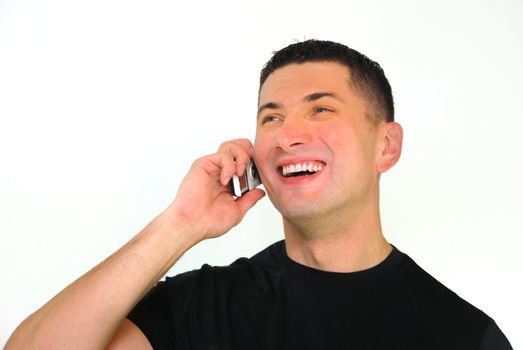 A portrait of a smiling Caucasian man talking on a mobile phone isolated over white background.