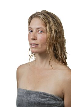 Blond woman out of bath in spa, relaxed, looks at camera