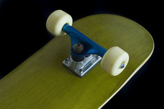 a green skateboard deck with blue truck on a black background