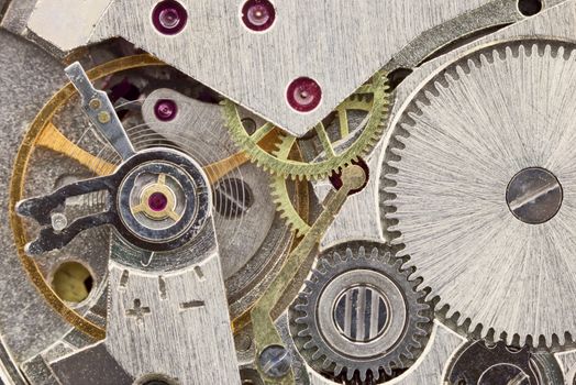 Ancient tiny metal clockwork close up background