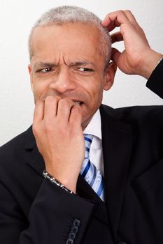 Stressed Businessman Biting His Nails And Scratching His Head