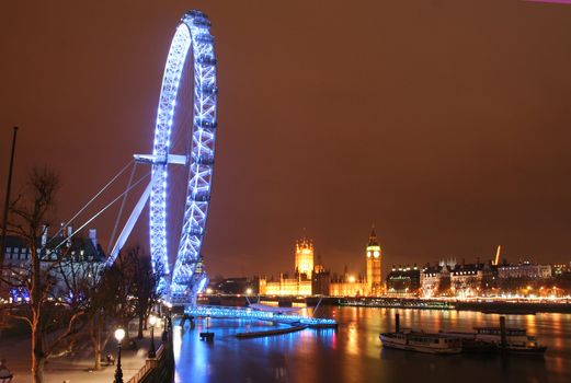 London, United Kingdom - December 27, 2007: The London Eye, the Thames and Westminster at night