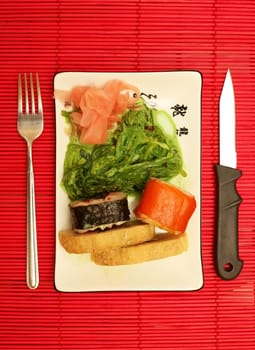 sushi and chopsticks close-up on red background