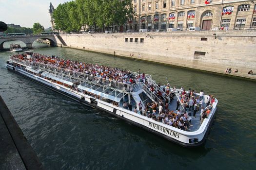 Giant canal boat with tourists in the Seine in Paris, France