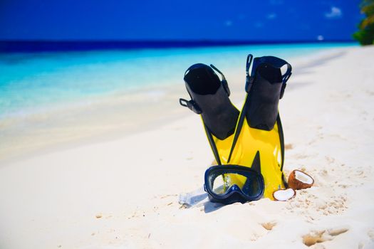 snorekl equipment on white sand beach at Maldives