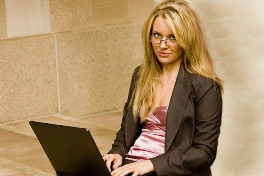 beautiful young business student typing on a laptop
