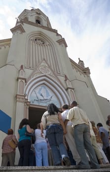 Low angle shot of a crowd of devotees entering a church (Iemanja Day in Brazil)