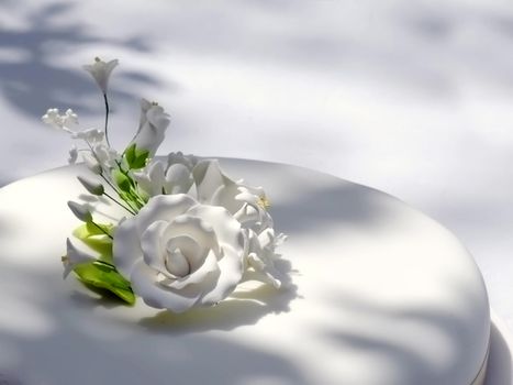 Detail of floral arrangement on wedding cake, made of confectionery