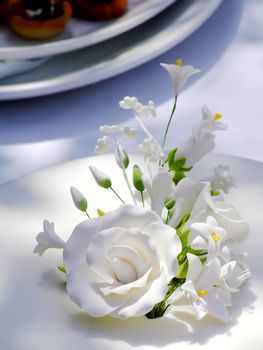 Detail of floral arrangement made out of confectionery, on wedding cake