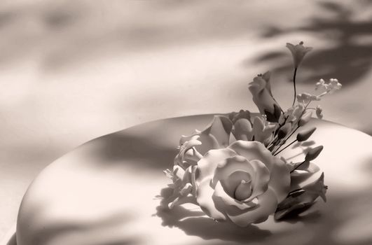 Detail of floral arrangement on wedding cake, made of confectionery