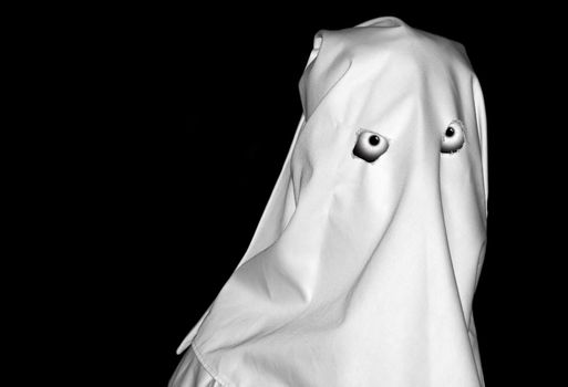 Spooky white figure over clear black backdrop