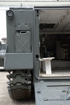 Military battlefield transport vehicle. Detail low angle shot from behind.