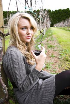 woman drinking wine at the vineyard