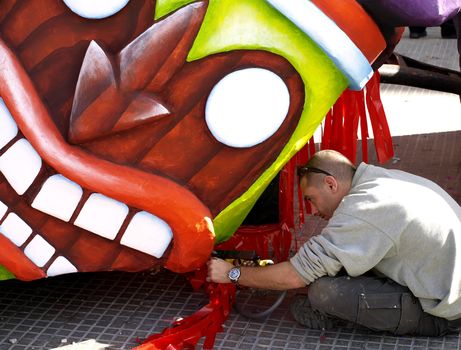 Artist applying final touches to float from the International Carnival of Malta 2008  