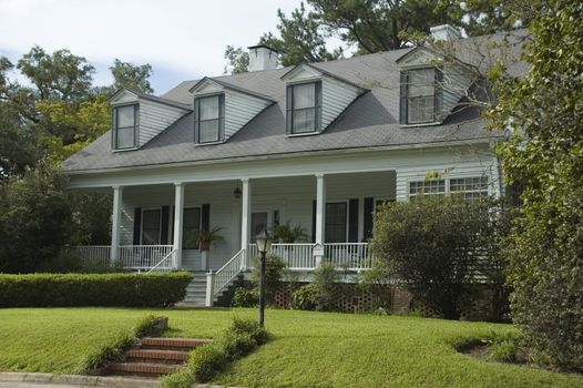 An old home with beautifully landscaped grounds.