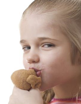 Cute little girl kissing her stuffed animal.