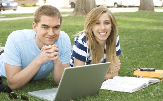 Two attractive students working together outside.