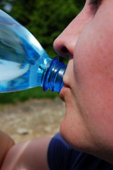 woman drinking water in mountains