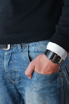 detail of classic refined denim. man's hand with smart watch