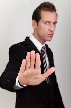 Business Man Making Stop Sign - focus on hand