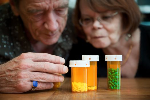 Senior couple closely examining intructions on prescription medications