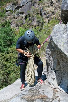 Men prepering to rappeling on waterfall