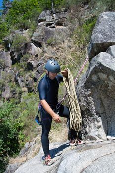 Men prepering to rappeling on waterfall