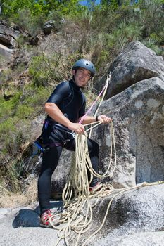 Men prepering to rappeling on waterfall