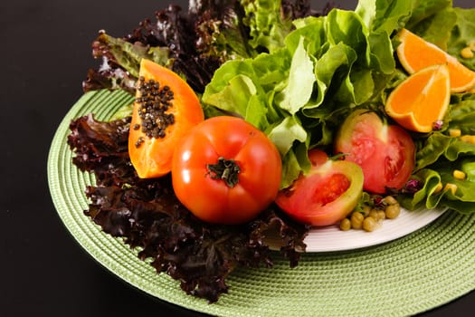 Composition of fruits and vegetables lettuce, orange, tomato, papaya
