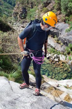 Men prepering to rappeling on waterfall