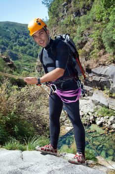 Men prepering to rappeling on waterfall