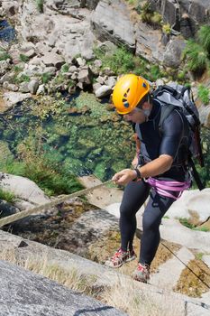 Men prepering to rappeling on waterfall