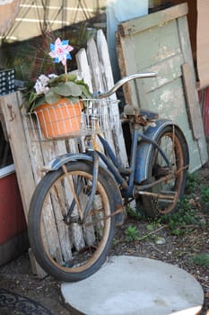 A vintage bike leaning against a wall outdoors.