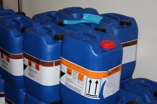 A stack of blue chemical containers in stock