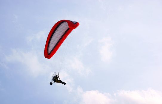 3 Wheel motorized parapent against a blue sky