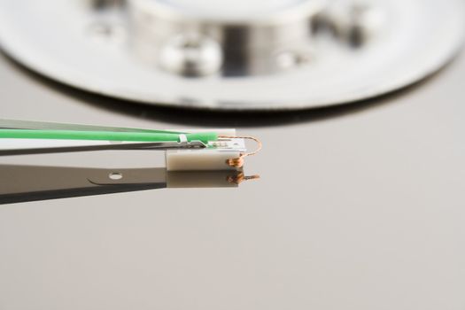 Close-up of the opened hard disc drive on the white background