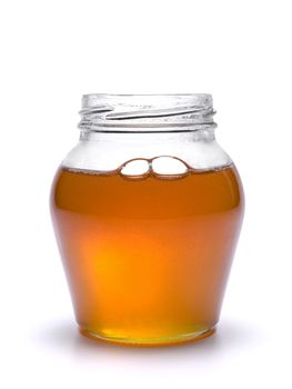 A jar full of honey. Isolated on white background.