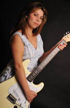 attractive young woman holding an electric guitar