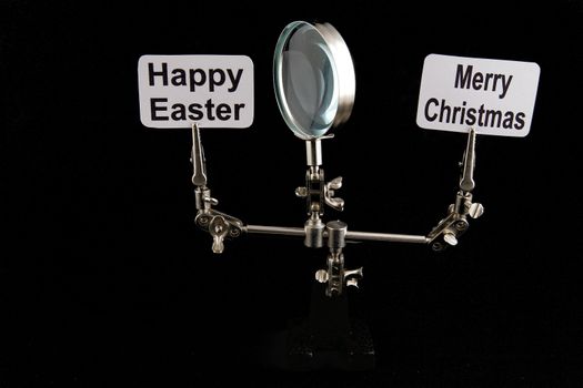 figure of steel man with "Happy Easter" and "Merry Chrostmas" inscriptions on black background