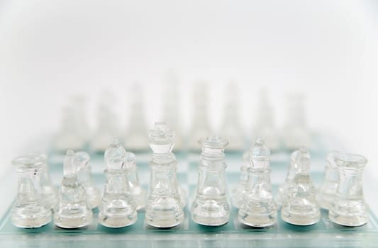 glass chess on the transparent chessboard