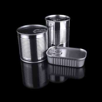 Three different tin cans isolated over a black background.