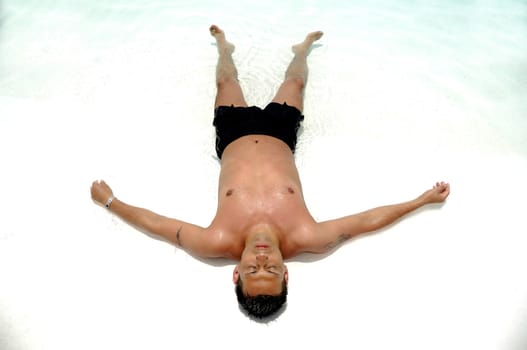 A man is relaxing in swimming pool