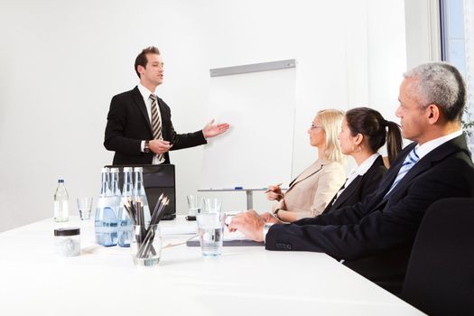 Businessman giving a presentation to his colleagues