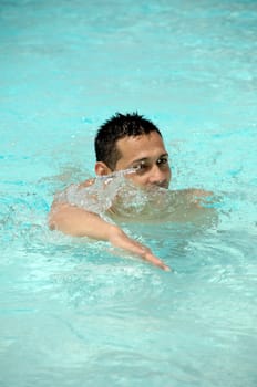 A man is swimming in a pool