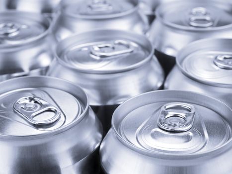 Several soda or beer cans. Shallow depth of field.